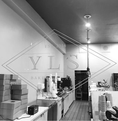 Black and white photo of YLS logo decal on storefront window